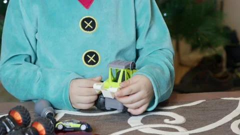 Cute boy elf assembling toys for kids in front of Christmas tree. Stock Footage 293730445