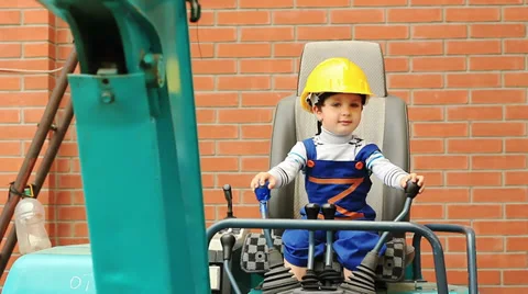 Cute boy as a excavator operator controls the levers Stockbeeldmateriaal 27699799