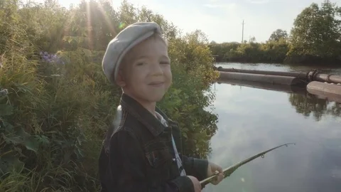 Cute boy is fishing on river Stock Footage 78634367