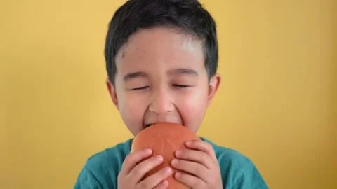 Cute boy happy to bite a burger Stock Footage 182338689