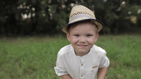 Cute boy in hat waving at camera. Video stock 140883171