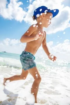 Cute boy is having fun on the beach Stock Photos