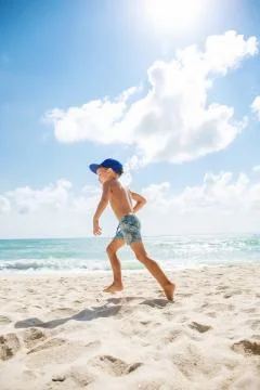 Cute boy is having fun on the beach Stock Photos