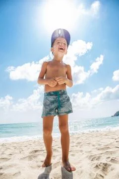 Cute boy is having fun on the beach Stock Photos