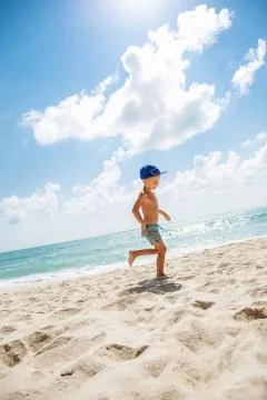 Cute boy is having fun on the beach 스톡 사진