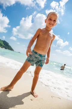 Cute boy is having fun on the beach Stock Photos