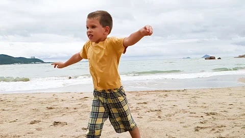 Cute boy jumping on beach. Stock Footage 266387316