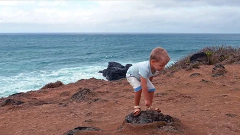 Cute boy jumping off the boulder slow motion Stock Footage 72727875