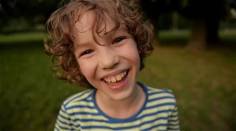 Cute boy laughing in the park, close-up, slow motion Video stock 63901531