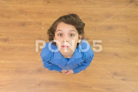 The cute boy look to the camera. View from above Stock Photos