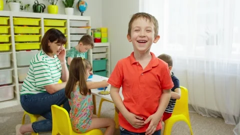A cute boy looks into the camera and laughs. Stock Footage 276922212