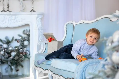 A cute boy opens a gift box in a New Year's atmosphere Foto stock