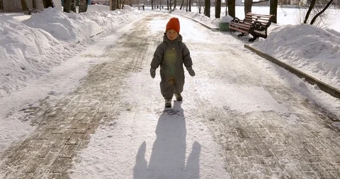 Cute boy park winter goes talks Stock Footage 105186743