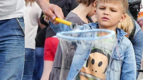 Cute boy plaiying soap bubbles Stock Footage 67613826