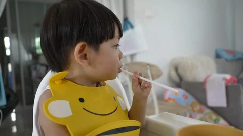 Cute boy playful bite a straw Stock Footage 110397895