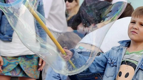 Cute boy playing bubbles city street Stock Footage 67614266