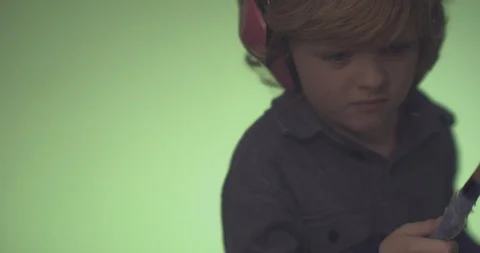 Cute boy playing drum with drumstick Stock Footage 99991397