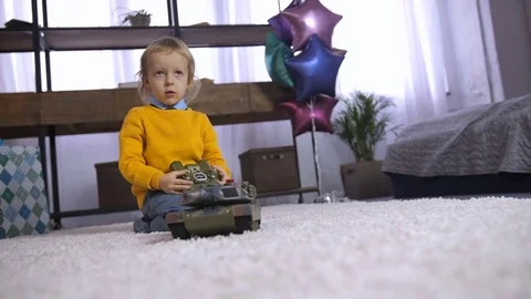 Cute boy playing with remote control toy at home Stock Footage 85103069
