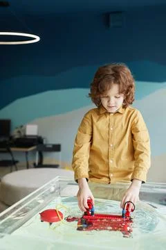 Cute Boy Playing with Robotic Boat Stock Photos