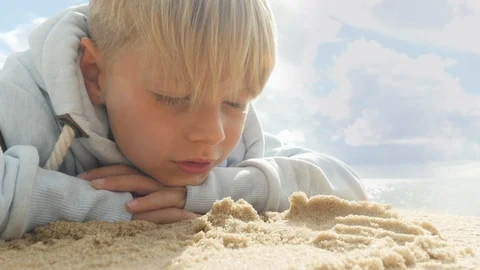 Cute boy playing in the sand Stock Footage 85609307