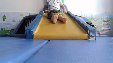 Cute boy playing slide in the room slow motion, 스톡 동영상 70788825