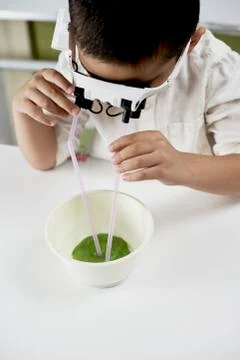 Cute boy playing with slime Stock Photos