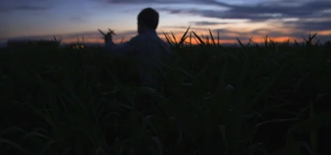 Cute Boy Playing With Toy Plane In Meadow At Dusk 库存影片 113070015
