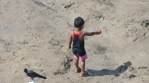Cute boy playing with water at beach Stock Footage 127345008