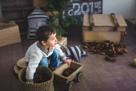 A Cute boy plays on a floor in a studio Stock Photos