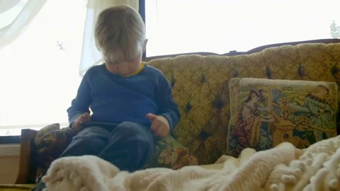 Cute boy plays on phone Stock Footage 76546764