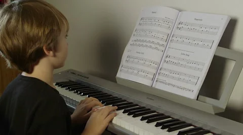 Cute boy plays piano Video stock 45621441