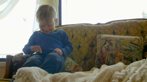 Cute boy plays on tablet Stock Footage 76546870