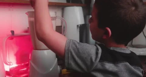 Cute Boy Preparing His Freshly Squeezed Banana Juice In The Morning , Stock Footage 143858111