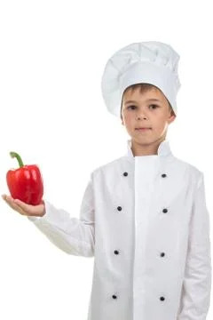 Cute boy with red pepper in Chef uniform on white background Stock-Fotos