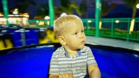 Cute boy riding on the carousel Stock Footage 101449674