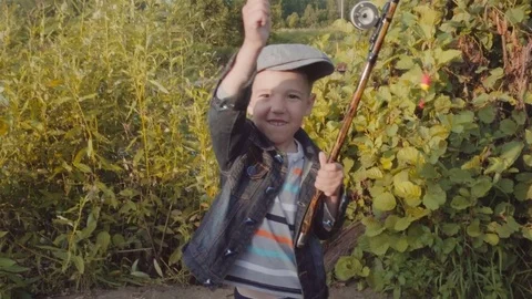 Cute boy is showing caught fish Stock Footage 78634865