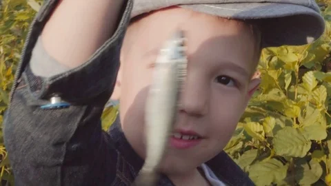 Cute boy is showing caught fish Stock Footage 78635011