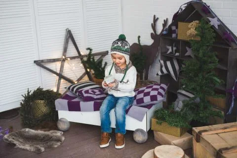A Cute boy sits in a decorated studio Stock Photos