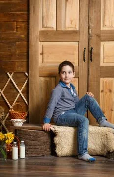 Cute boy sitting on a bench Fotos de archivo