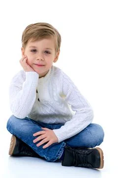 Cute boy sitting on floor Stock Photos