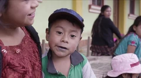 Cute boy sitting with his sisters and having a chocolate, Guatemala Stock Footage 63054751