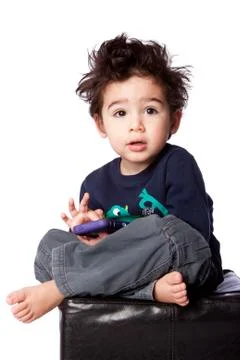 Cute boy sitting with mobile device Stock Photos