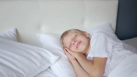Cute boy is sleeping in white bed. Child is sleeping sweetly. Strong healthy Stock Footage 159063577