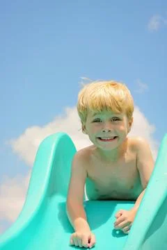 Cute boy on slide Stock Photos