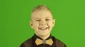 The cute boy smile on the green background 4k or 4k+ Resolution
