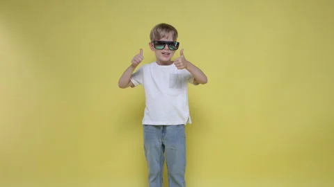 A cute boy smiles and gestures with his thumb up Stock Footage 282107288