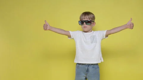 A cute boy smiles and gestures with his thumb up Stock Footage 282107557