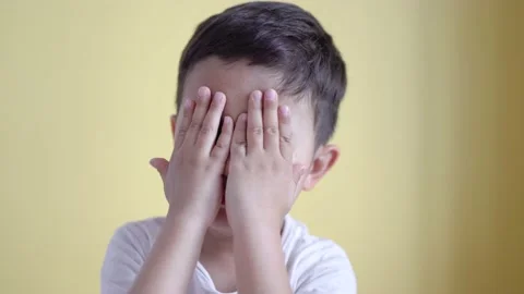 Cute boy smiling and covering his face on colour background. Stock Footage 195039331
