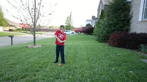 Cute boy spraying silly string in yard Stock Footage 10881166