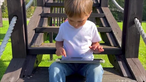 Cute boy studing on digital tablet computer. Development application for little Stock Footage 252071444